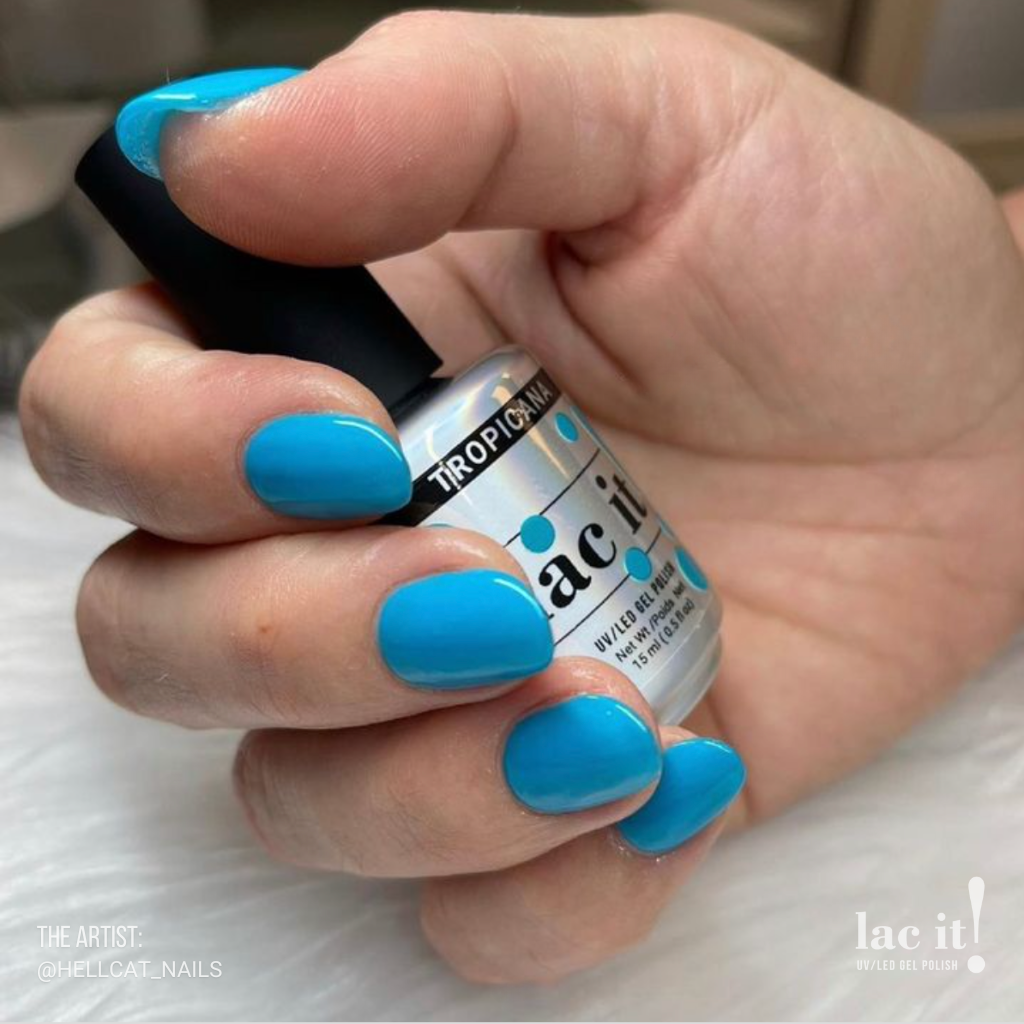 en Vogue Lac It! Tropicana rich aqua blue crème that glows in the dark UV/LED gel nail polish for professional nails and extensions on short round manicured nails holding polish bottle